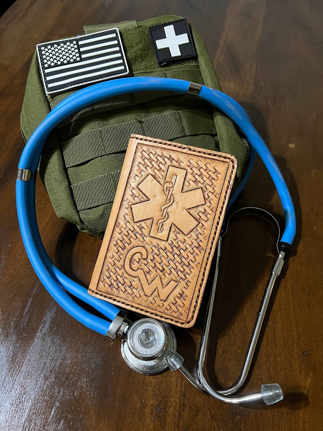 Custom hand-tooled leather EMT notebook case with Star of Life emblem and basket weave pattern