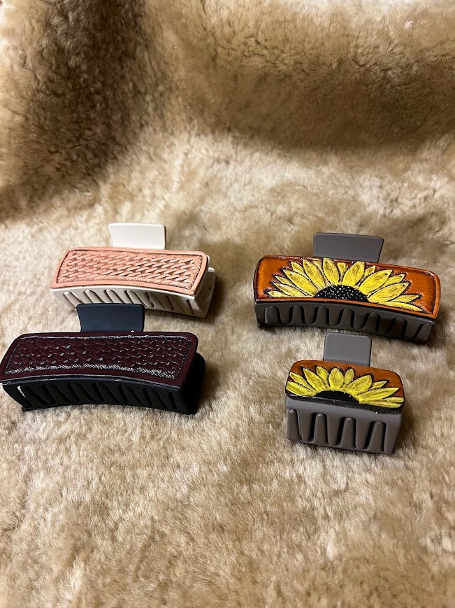 Custom hand-tooled leather hair clips in various styles including basketweave, sunflower, and geometric patterns